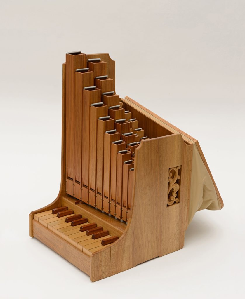 Image of a portative organ, from the side with bellows out.